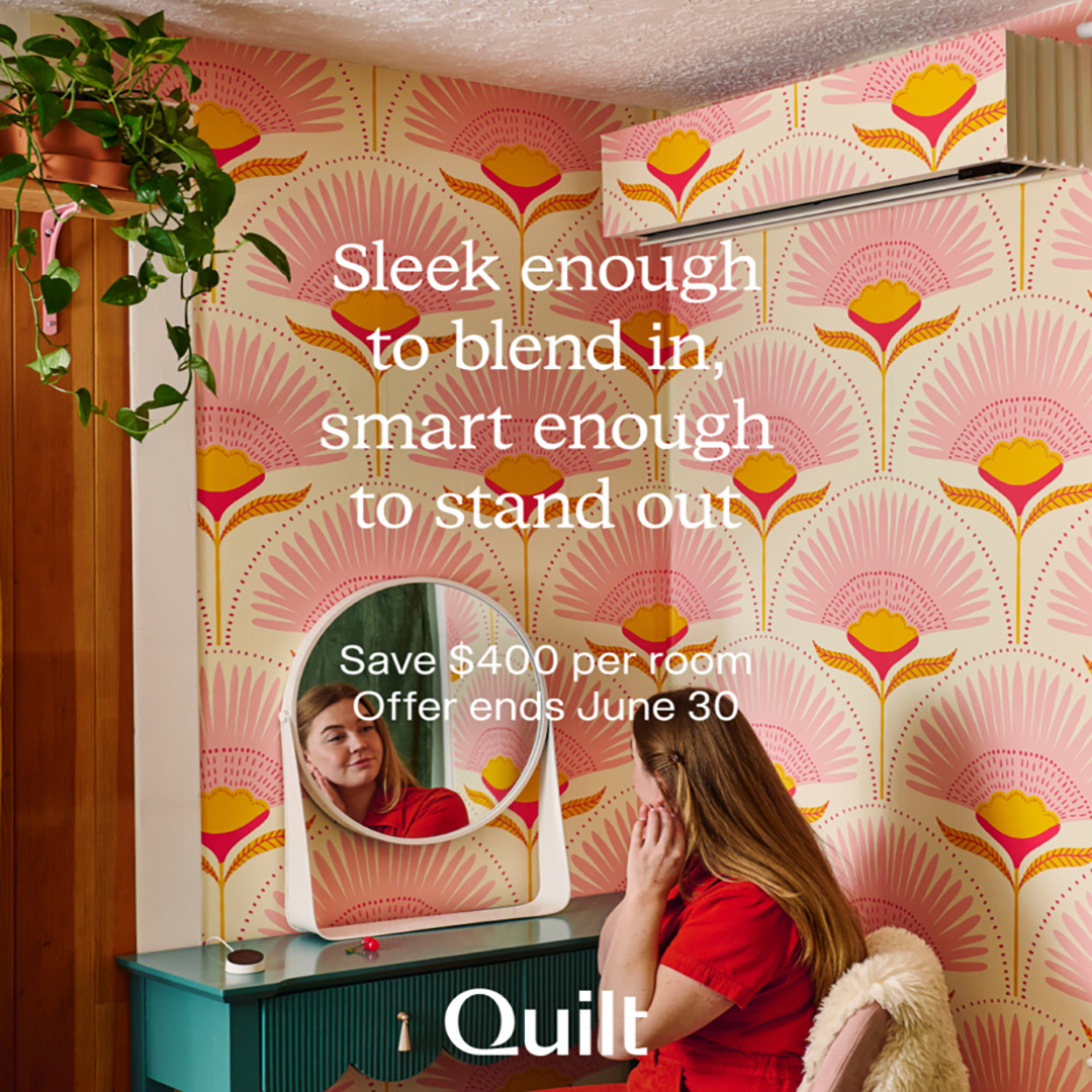 A woman with long red hair sits at a teal vanity in a room with bold, colorful wallpaper and a potted plant. Text reads: Sleek enough to blend in, smart enough to stand out. Save $400 per room. Offer ends June 30. Quilt.