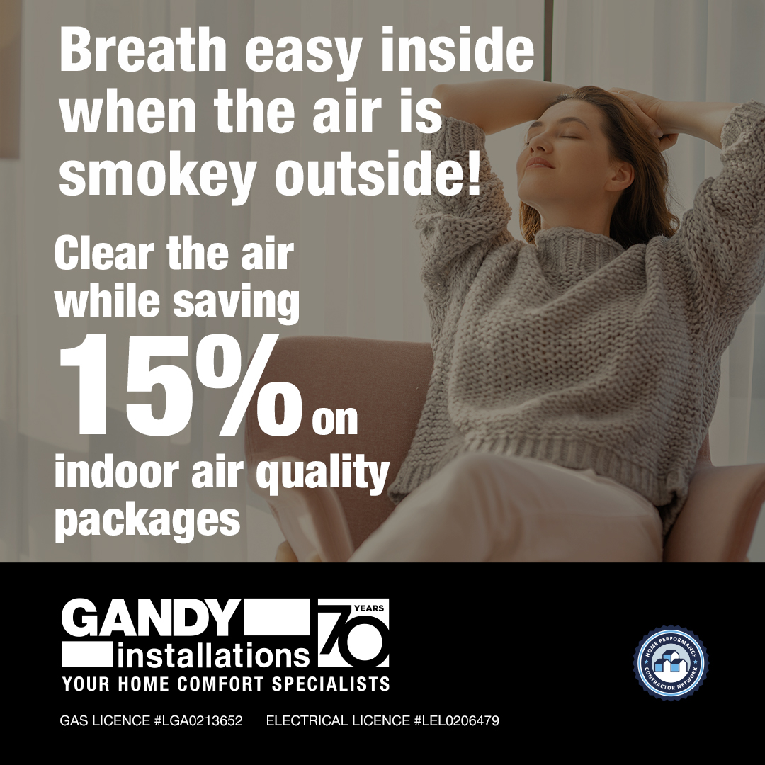 A relaxed woman sits indoors with her hands behind her head. Text overlays promote a 15% discount on indoor air quality packages from Gandy Installations, emphasizing comfort and clean air during smoky conditions.